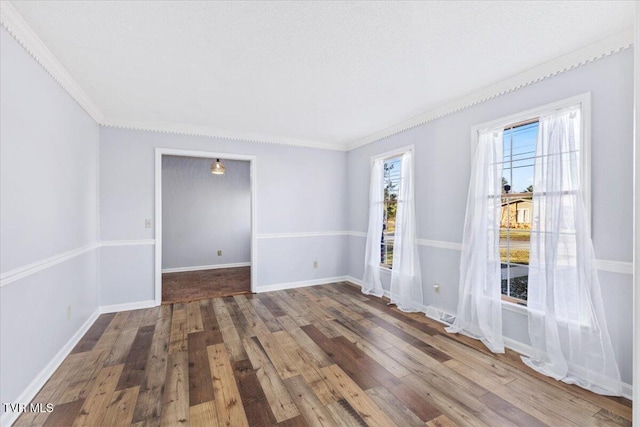 unfurnished room with wood-type flooring and ornamental molding