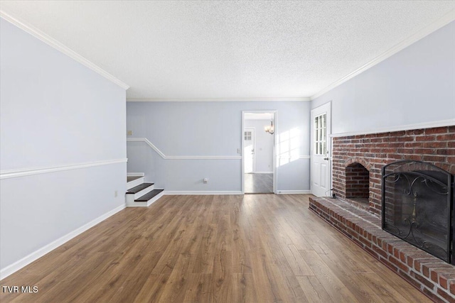 unfurnished living room with a fireplace, ornamental molding, a textured ceiling, and hardwood / wood-style flooring