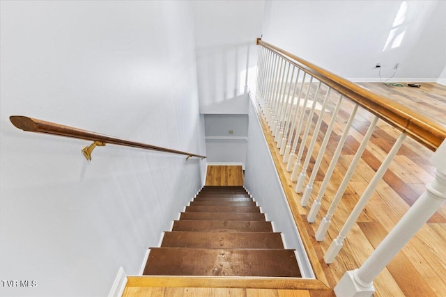 stairs featuring hardwood / wood-style floors