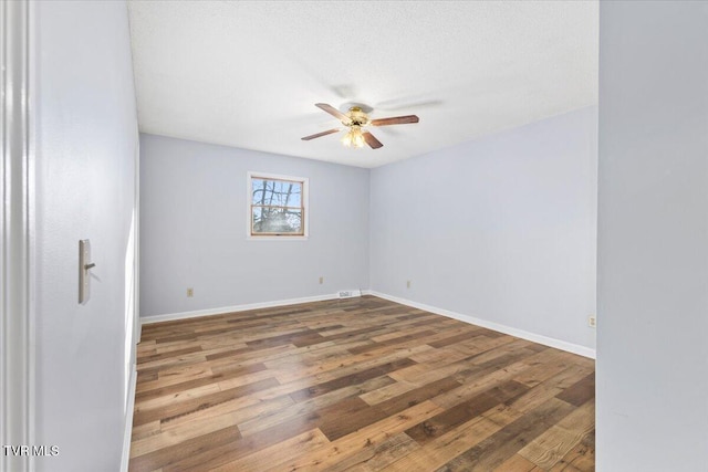 unfurnished room featuring ceiling fan, hardwood / wood-style floors, and a textured ceiling