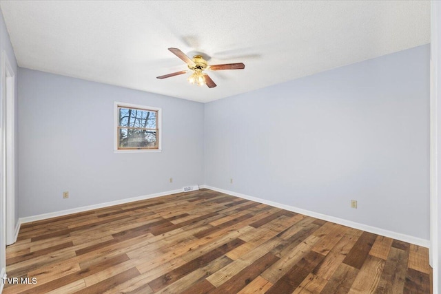 unfurnished room featuring hardwood / wood-style flooring, ceiling fan, and a textured ceiling