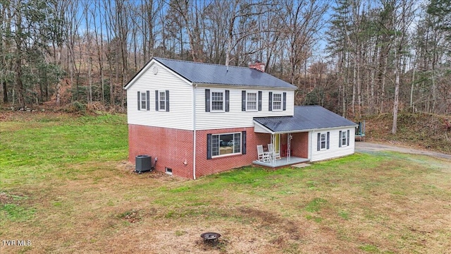 311 Dry Fork Rd, Del Rio, TN 37727 - view of front of property with brick siding, covered porch, a metal roof, and a front yard