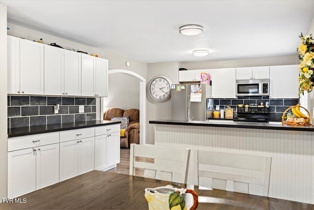 311 Dry Fork Rd, Del Rio, TN 37727 - kitchen featuring appliances with stainless steel finishes, dark countertops, tasteful backsplash, and white cabinets