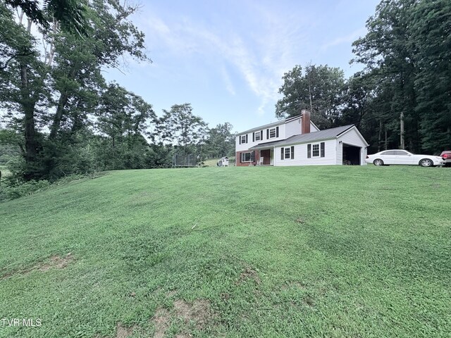 311 Dry Fork Rd, Del Rio, TN 37727 - view of green lawn with an attached garage