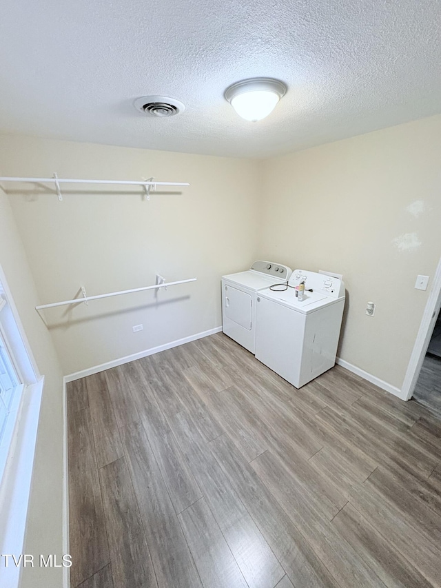311 Dry Fork Rd, Del Rio, TN 37727 - laundry room with independent washer and dryer, a textured ceiling, and light wood finished floors