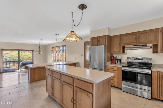 kitchen featuring plenty of natural light, a kitchen island, decorative light fixtures, and appliances with stainless steel finishes