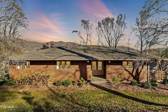 view of front of property with a mountain view and a yard