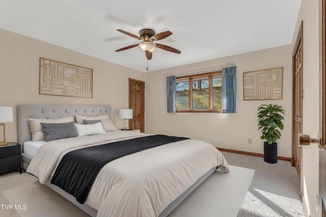 bedroom featuring light carpet and ceiling fan