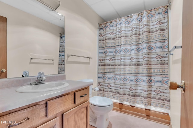 bathroom featuring a shower with shower curtain, tile patterned floors, vanity, and toilet