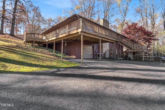 view of home's exterior featuring a garage and a deck