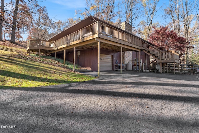 view of home's exterior featuring a garage and a deck