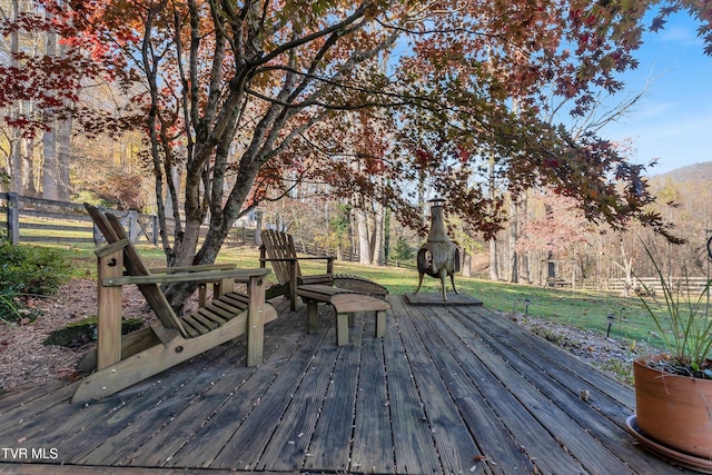 wooden terrace with a lawn