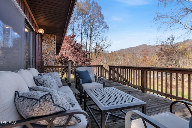 wooden deck featuring outdoor lounge area and a mountain view