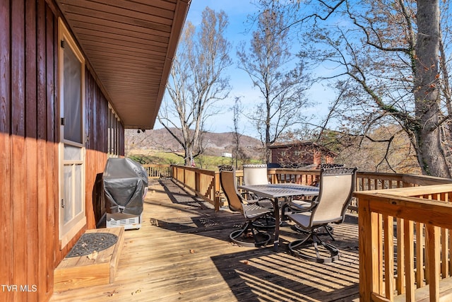 wooden deck featuring a grill and a mountain view