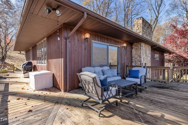 deck with an outdoor hangout area and a grill