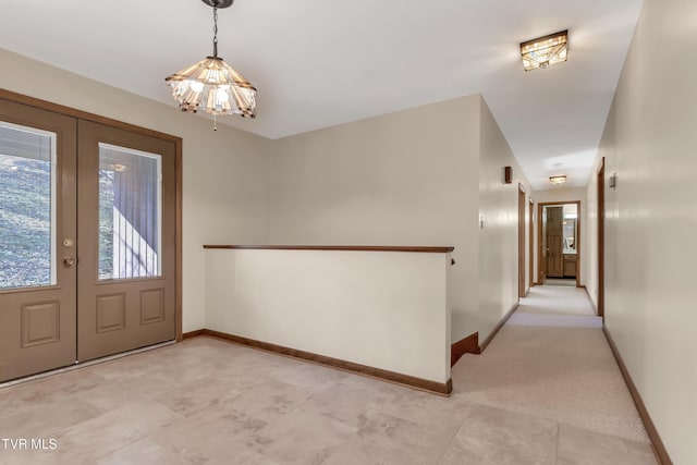 foyer with french doors and an inviting chandelier