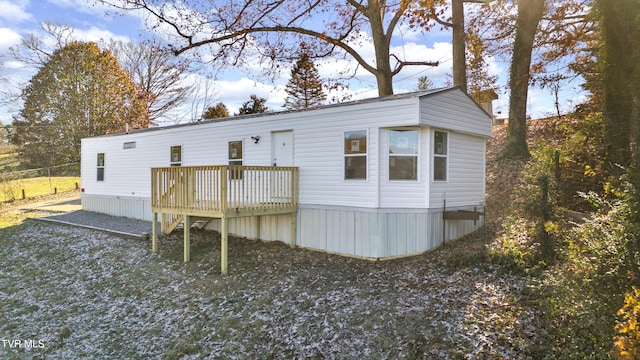 rear view of house with a wooden deck