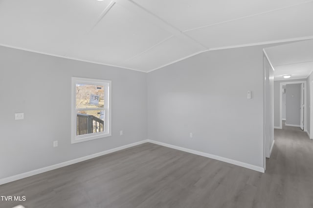 spare room with wood-type flooring and vaulted ceiling