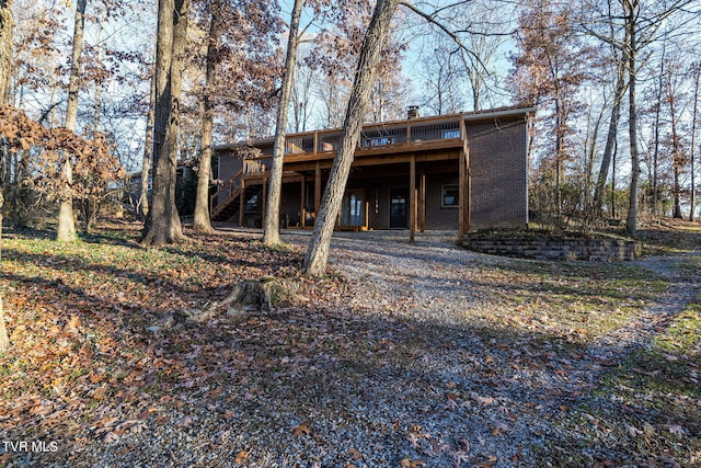 back of house with a wooden deck