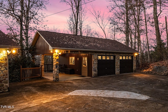 view of garage at dusk