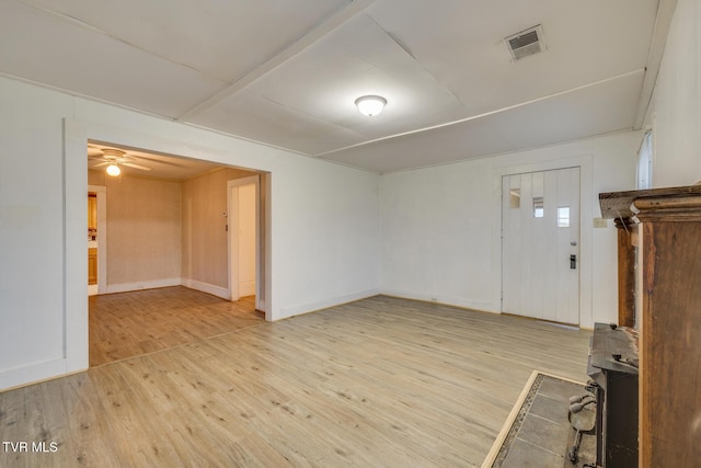 unfurnished living room featuring ceiling fan and light wood-type flooring