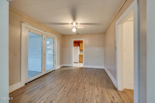 spare room featuring light hardwood / wood-style flooring, ceiling fan, and ornamental molding