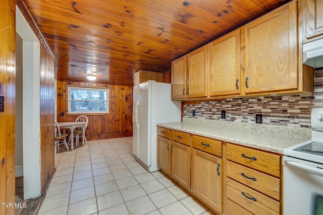 kitchen with white appliances, wooden walls, tasteful backsplash, light tile patterned flooring, and wood ceiling