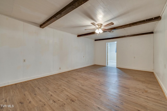 unfurnished room with beamed ceiling, light hardwood / wood-style floors, and ceiling fan