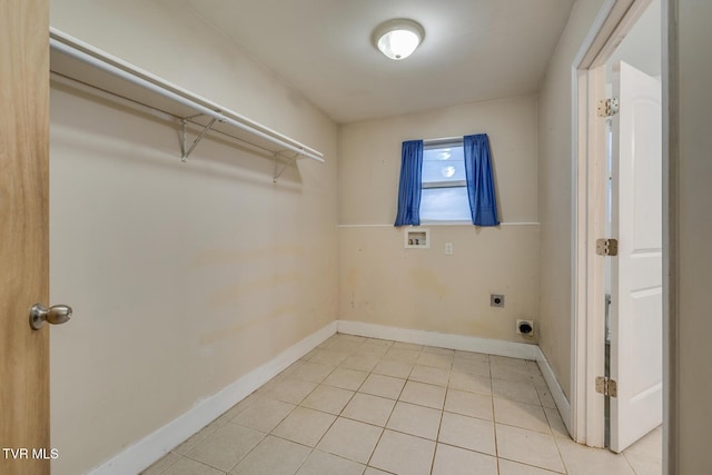 washroom featuring hookup for an electric dryer, light tile patterned floors, and hookup for a washing machine