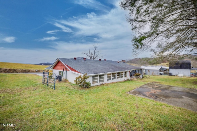 back of property featuring a yard