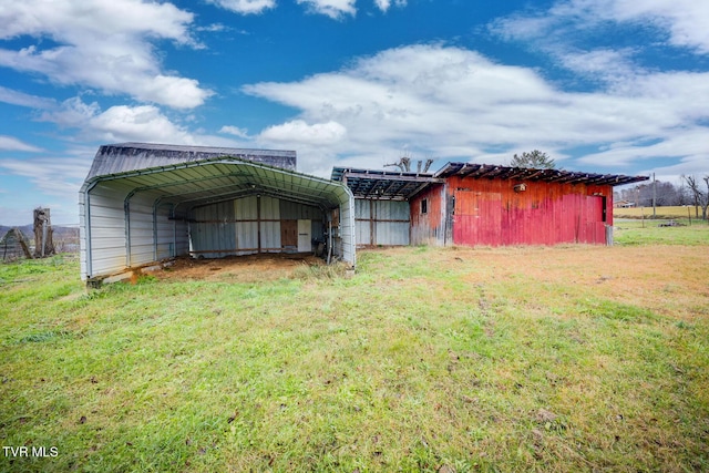 rear view of house featuring a carport and a lawn