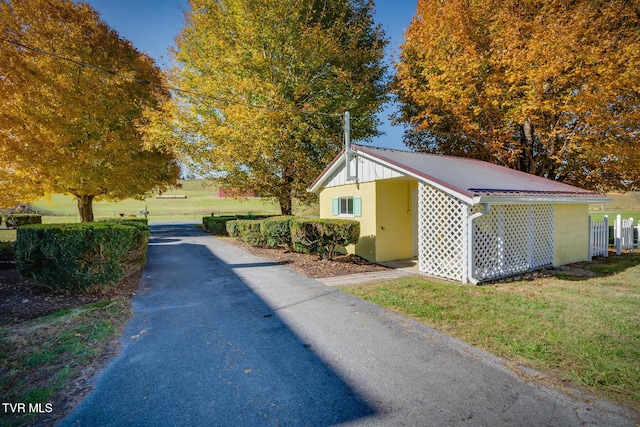 view of property exterior with a yard