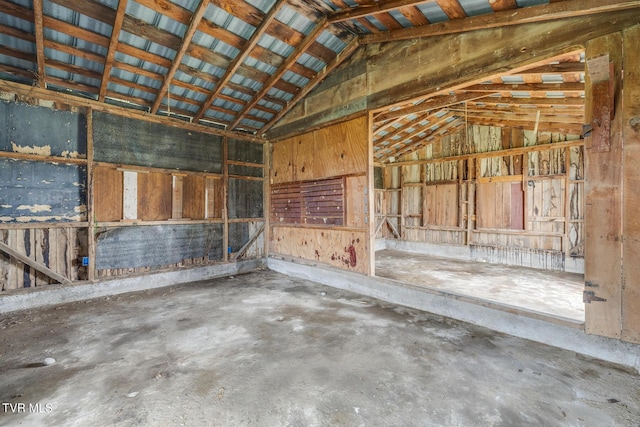 misc room featuring concrete flooring and lofted ceiling