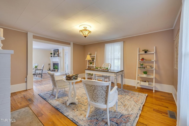 dining space featuring hardwood / wood-style flooring and crown molding