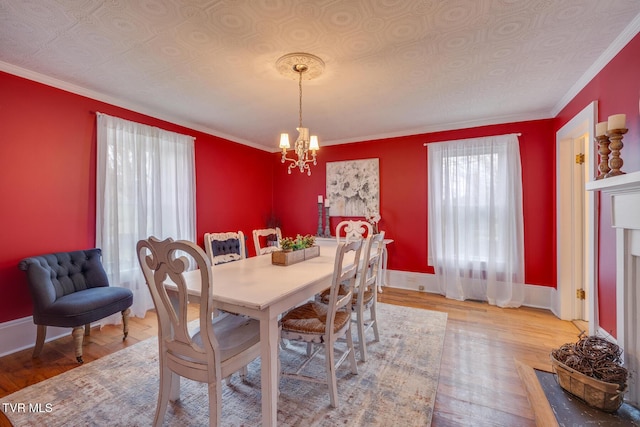 dining room featuring crown molding, hardwood / wood-style floors, and a chandelier