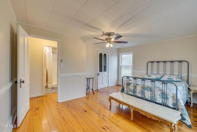 bedroom with light hardwood / wood-style flooring, ceiling fan, and ornamental molding