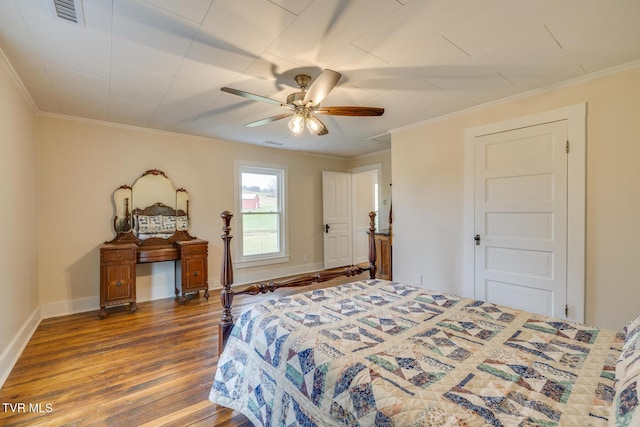 bedroom with ceiling fan, hardwood / wood-style floors, and ornamental molding