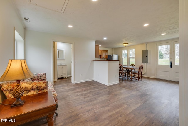 living room featuring electric panel, a textured ceiling, and hardwood / wood-style flooring