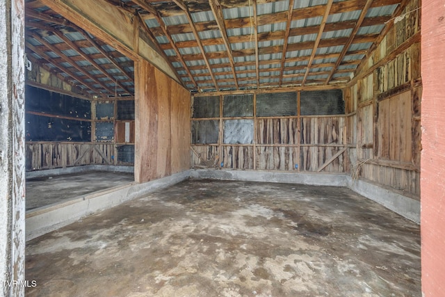 miscellaneous room with concrete floors and vaulted ceiling