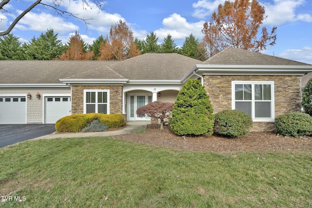 ranch-style home with a front yard and a garage