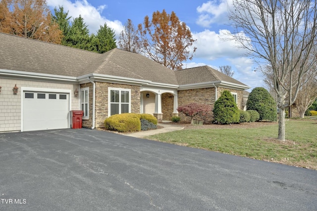 view of front of home featuring a front yard and a garage