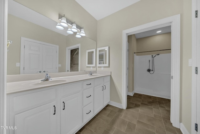 bathroom with vanity and a shower