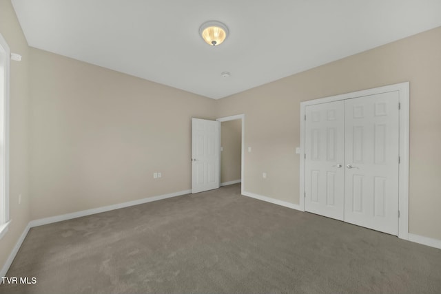 unfurnished bedroom featuring a closet and carpet floors