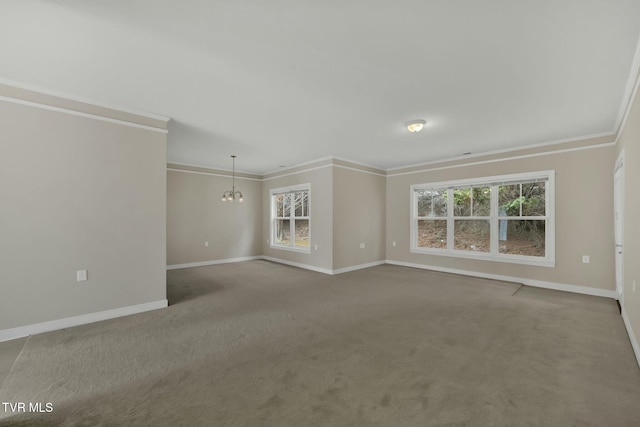 unfurnished room with carpet flooring, a notable chandelier, a healthy amount of sunlight, and crown molding