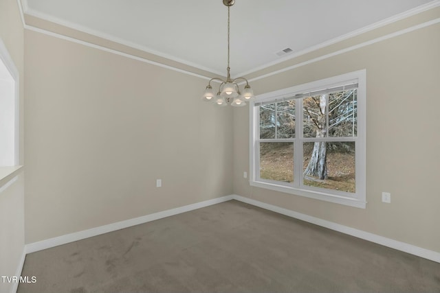 spare room with carpet floors, a chandelier, and ornamental molding