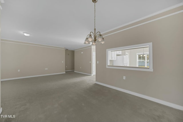 unfurnished living room with carpet flooring, ornamental molding, and a chandelier