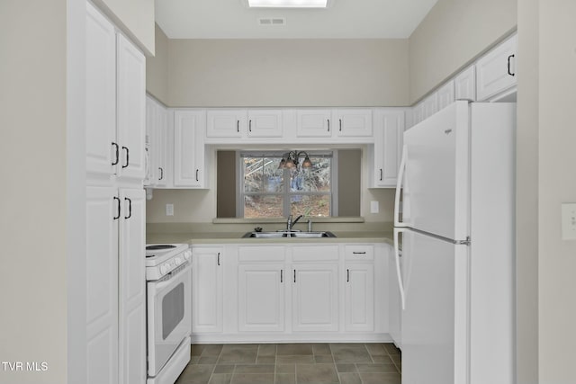 kitchen with white cabinets, white appliances, and sink