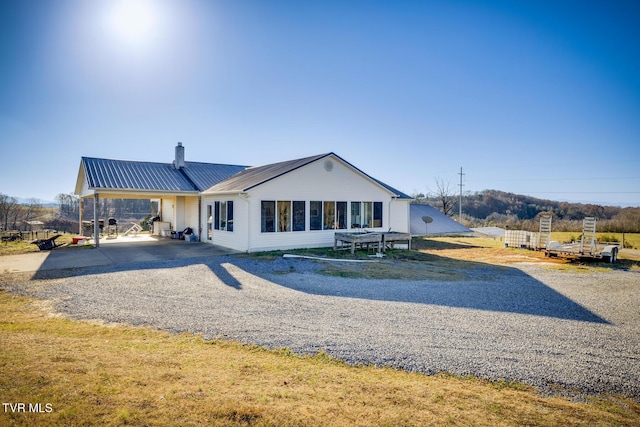 rear view of property featuring a carport