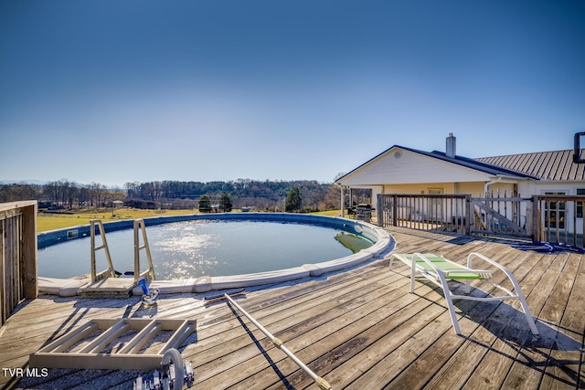 view of swimming pool featuring a deck