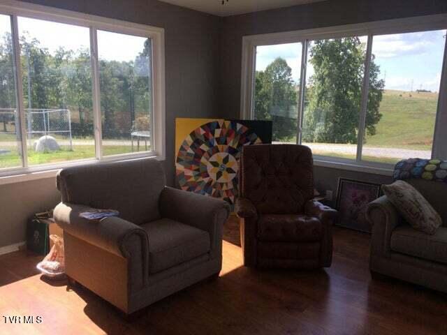 sitting room featuring a wealth of natural light and wood-type flooring